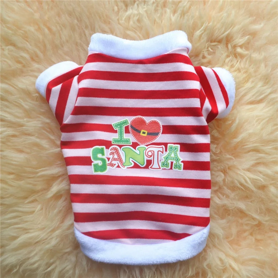 A red and white striped holiday letter print pet sweatshirt lying on a fluffy yellow background.