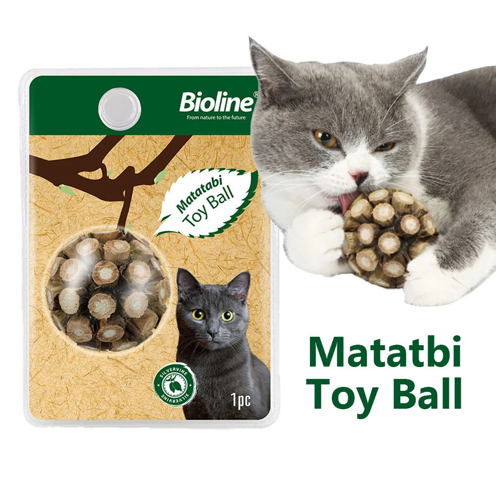A gray cat is playing with a Matatbi Toy Ball, shown next to the product packaging.