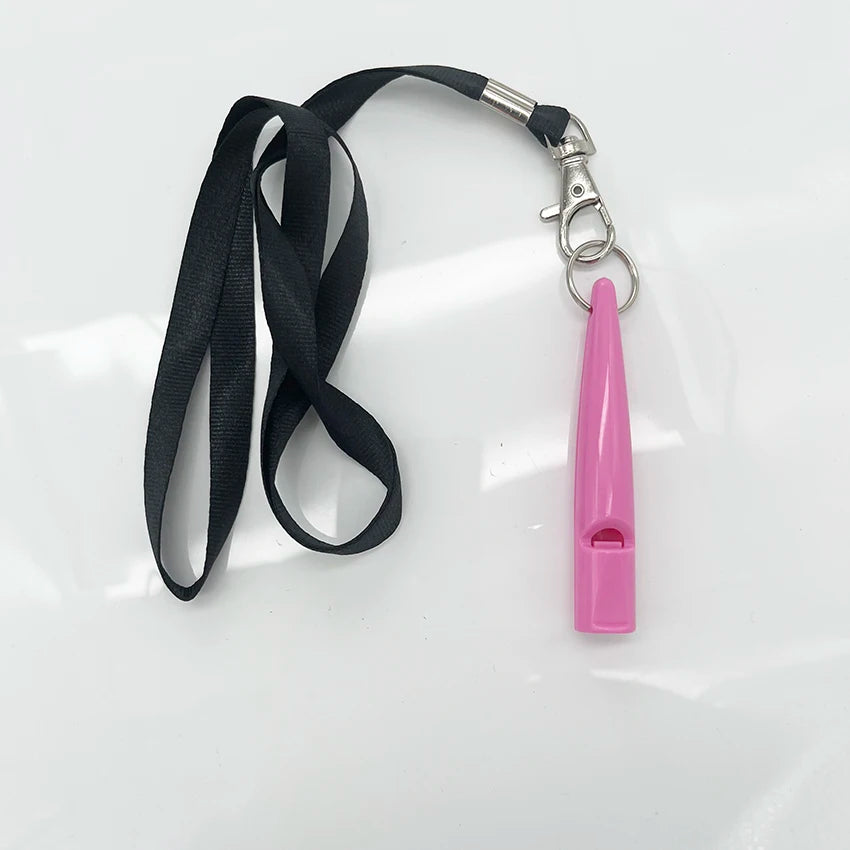 A pink ultrasonic dog training whistle attached to a black lanyard and metal clip.