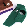 A green fleece dog sweater with a paw print design shown next to stacked sweaters.