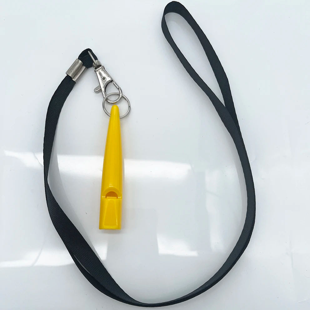 A yellow ultrasonic dog training whistle attached to a black lanyard and metal clip.