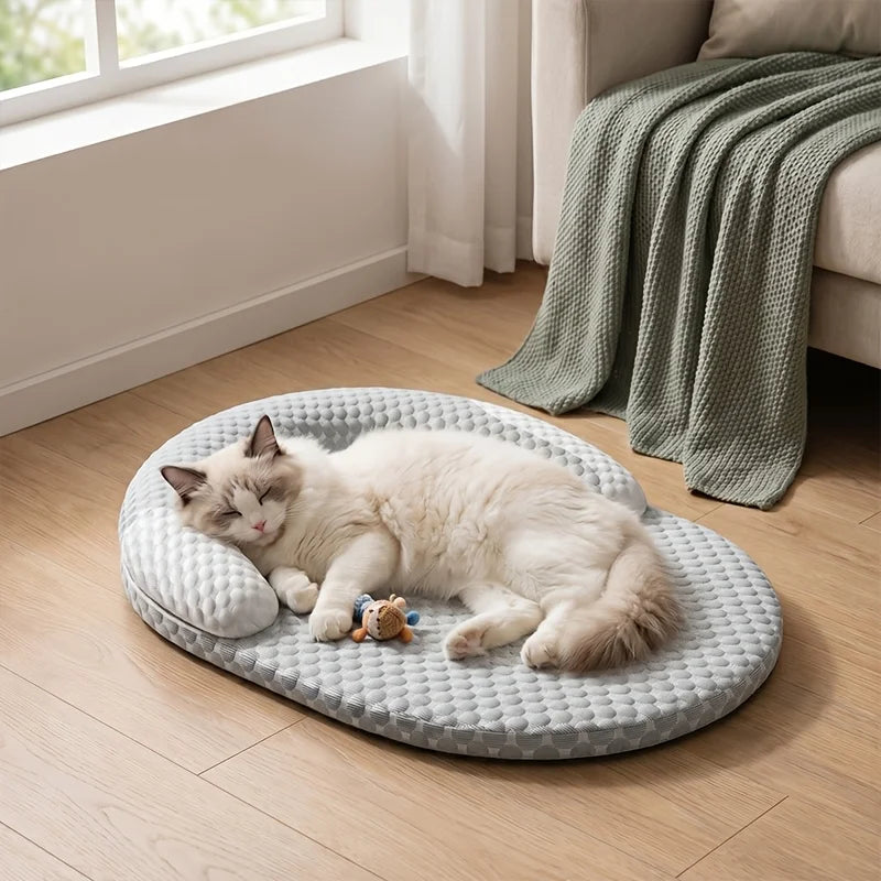 A fluffy white cat is relaxing on a gray breathable cooling pet bed indoors.