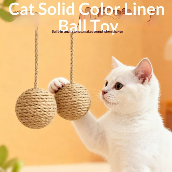 A white cat is playing with a natural sisal ball toy for interactive play.