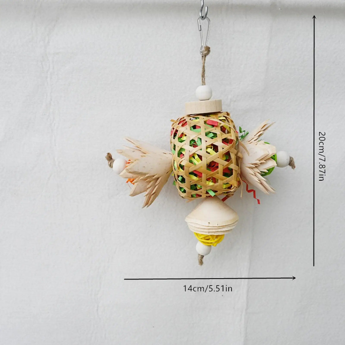 A natural wood parrot foraging and chew toy hanging from a cord against a white background.