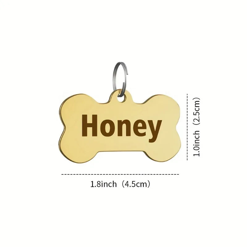 Gold bone-shaped stainless steel pet ID tag with a keyring and engraved word Honey
