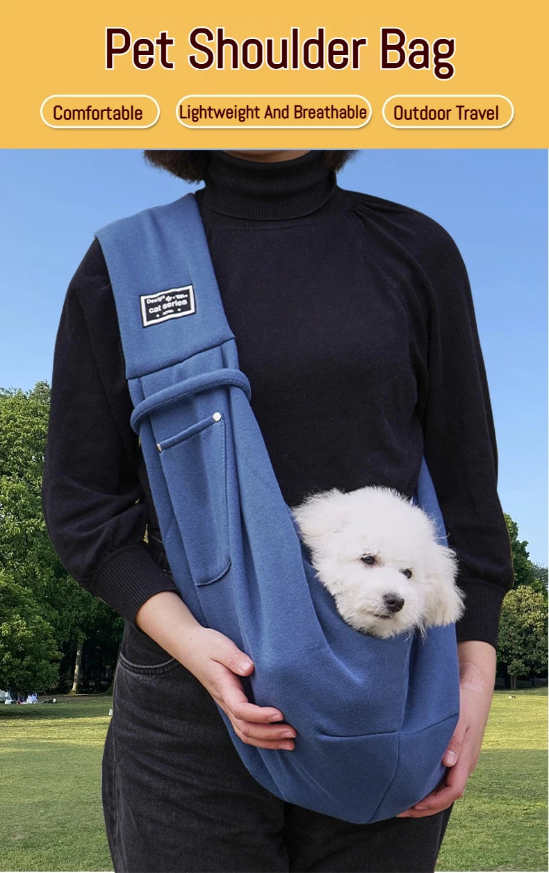 A person is wearing a blue pet shoulder bag while standing outdoors.