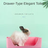 A pink drawer-type elegant toilet with a fluffy white rabbit sitting inside.