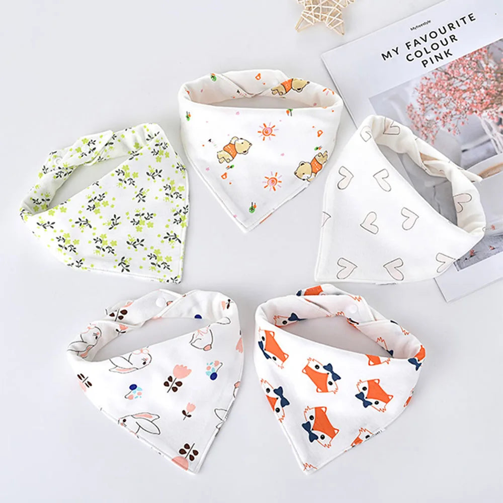 A set of five white cotton triangle baby bibs featuring various cartoon animal prints on a white background.