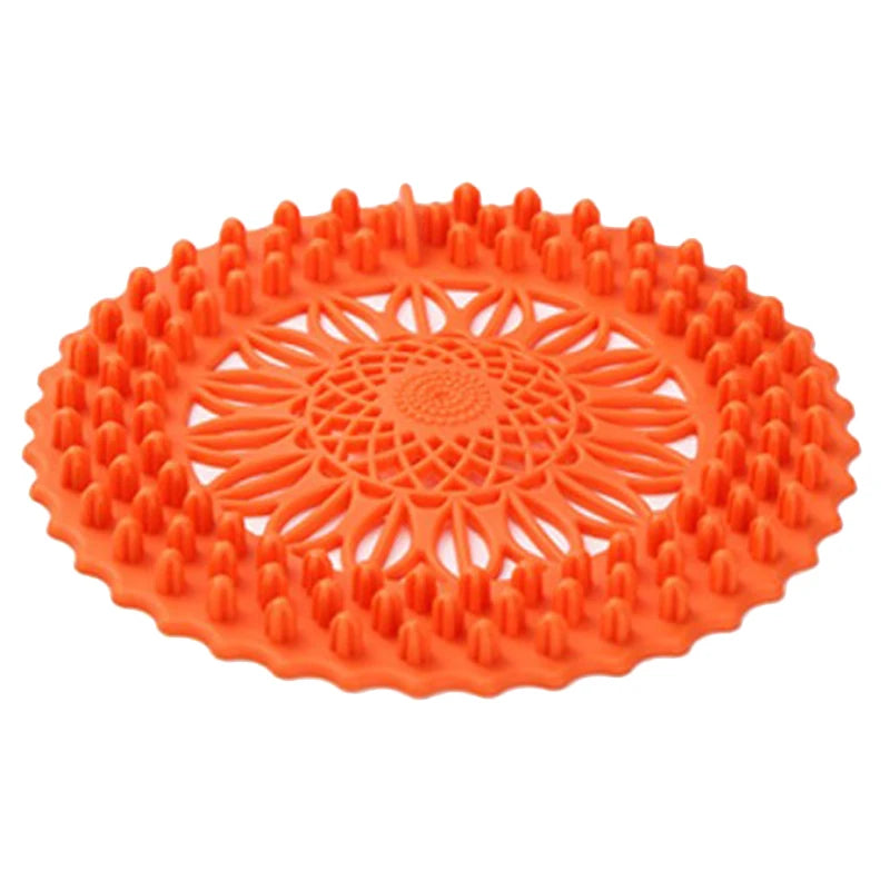 Orange flexible silicone drain cover with a handle for hair and debris