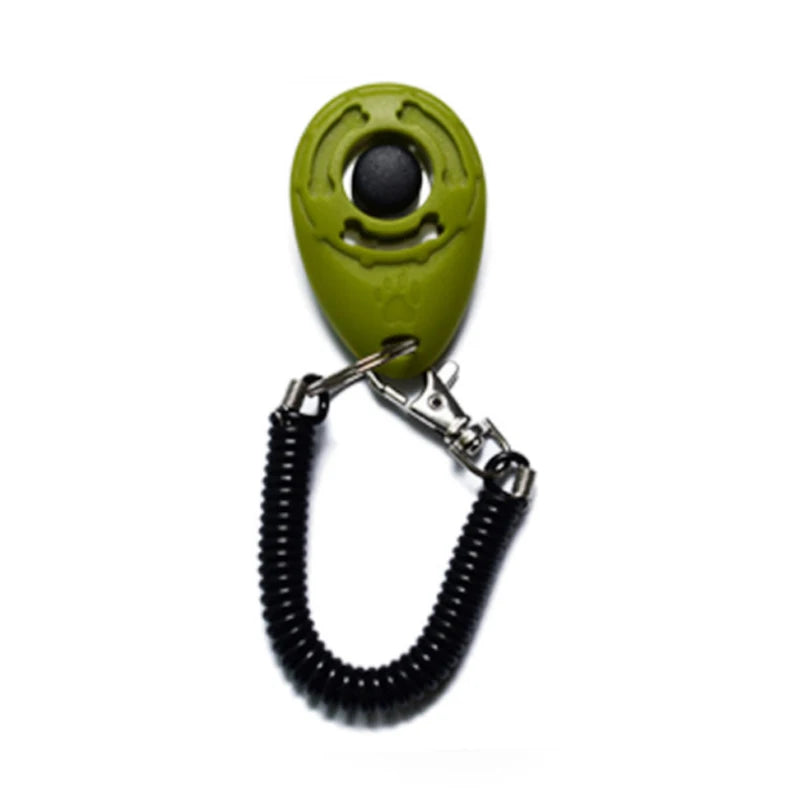 A bright lime green pet training clicker with a black eye and a metal wrist strap.