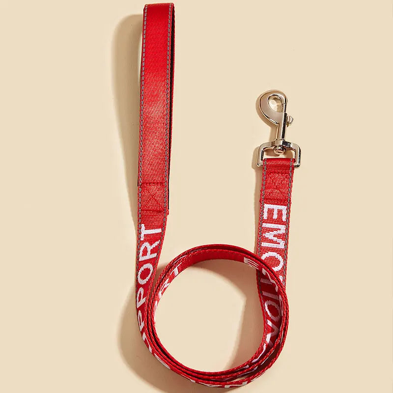 A red reflective service dog leash with a padded neoprene handle and metal clip.