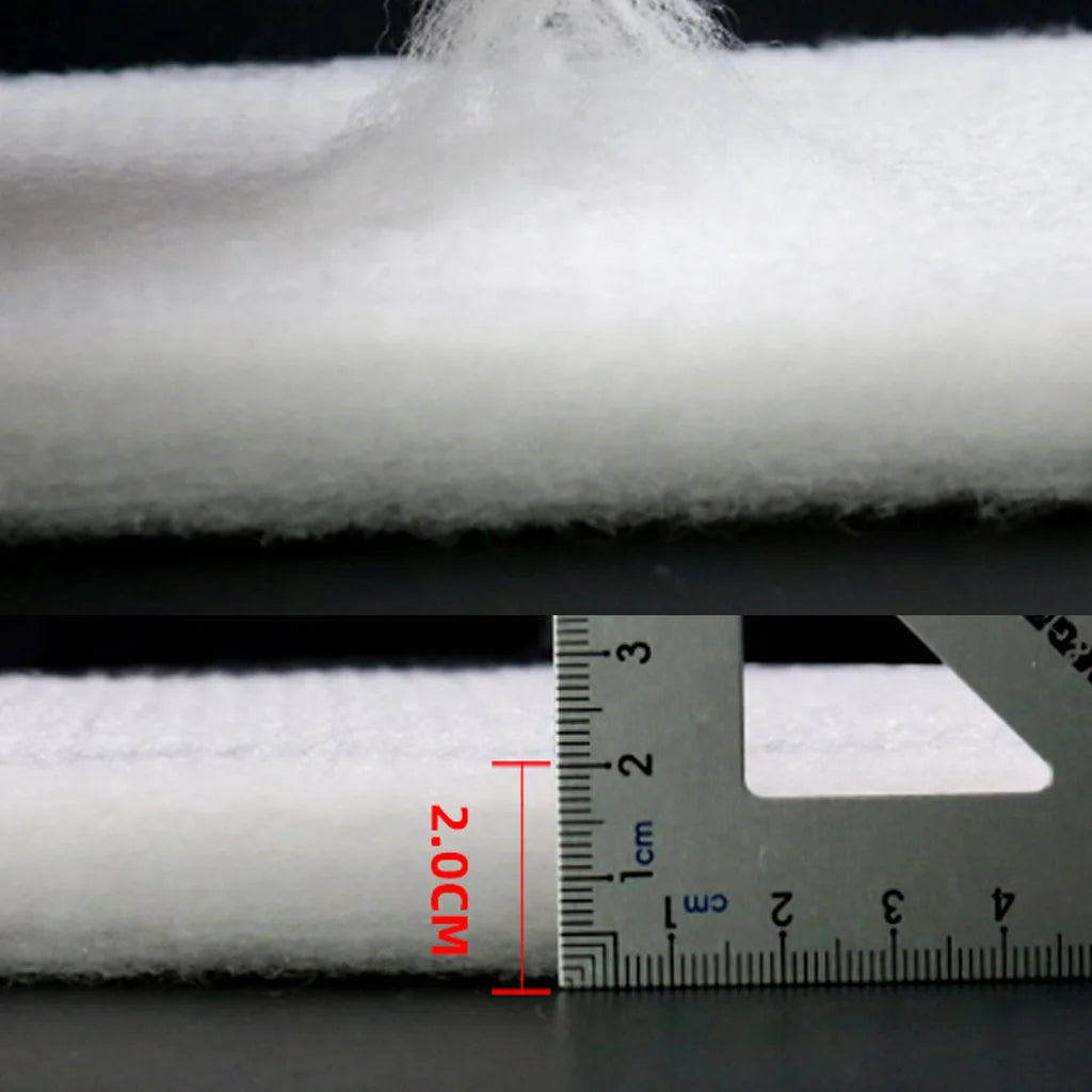 Cross-section view of a white dual-density aquarium filter sponge showing its thickness and structure against a ruler.