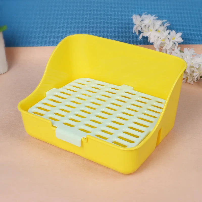 A yellow anti-overturn drawer litter box with a grid tray is shown on a light surface.