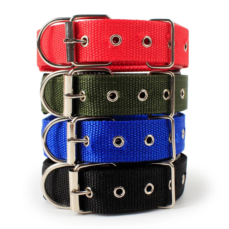 A stack of four soft cotton adjustable dog collars in red, olive green, blue, and black.