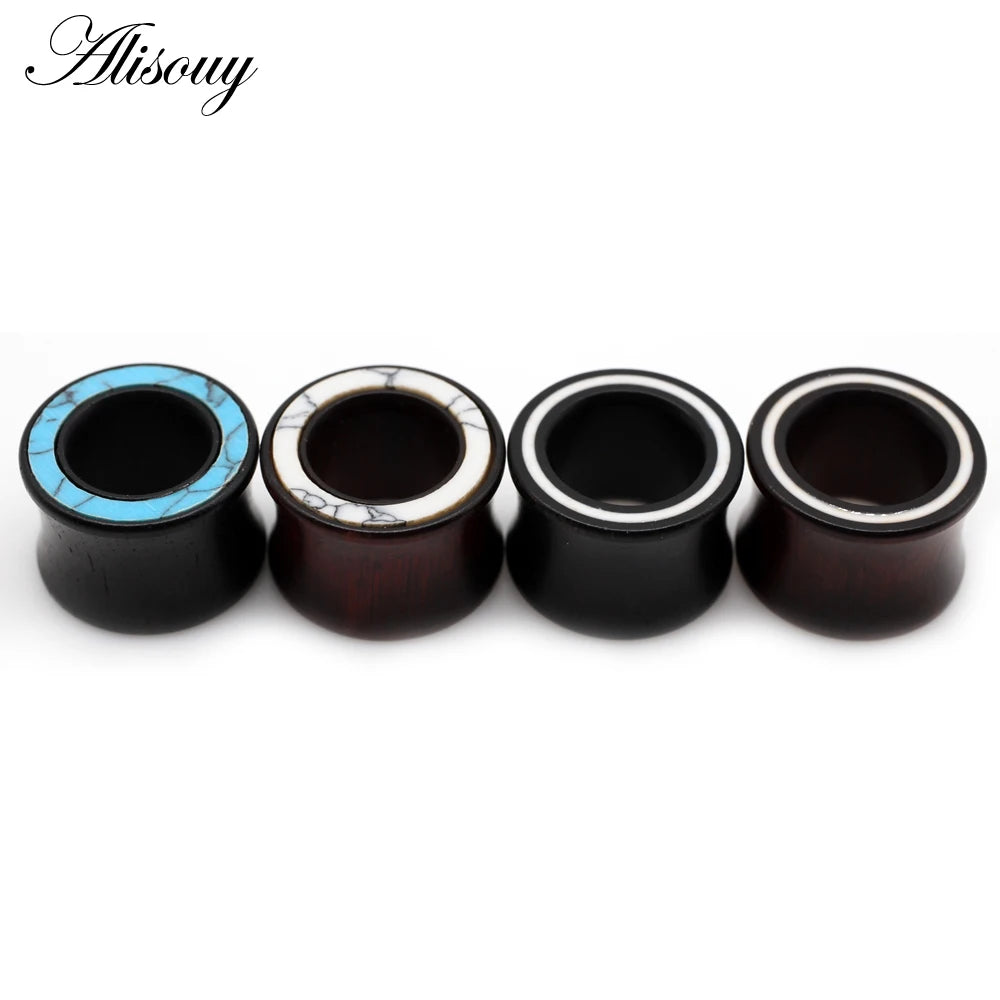 A set of handmade wood ear tunnels with blue stone inlay, showing various finishes.