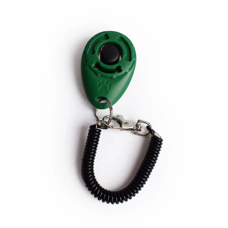 A green pet training clicker with a black tip attached to a black wrist strap.