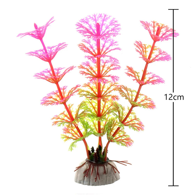 A vibrant artificial aquarium plant with pink and orange fronds growing from a root base.