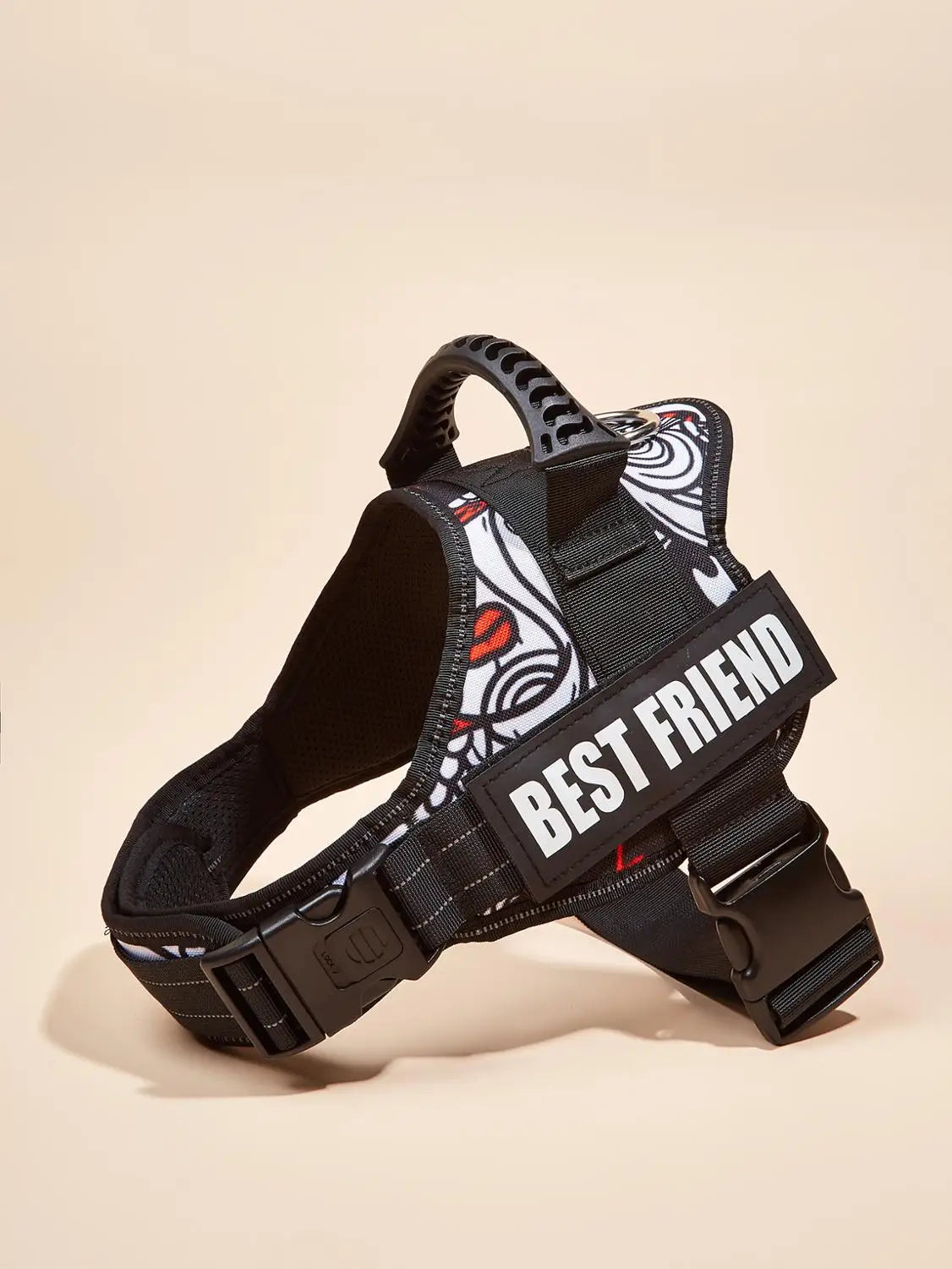A black dog harness vest with white and red graphic stripes and a black strap is shown against a light background.
