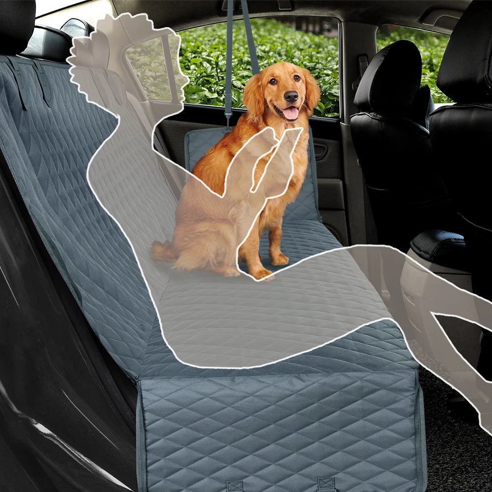 A golden retriever sits on a blue car seat cover featuring a hammock and mesh window.