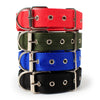 A stack of four soft cotton adjustable dog collars in red, olive green, blue, and black.