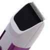 Close-up view of a white and purple electric pet grooming clipper with a black cutting head.