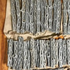 A collection of natural cholla cactus wood shrimp nests for aquariums arranged on brown paper.
