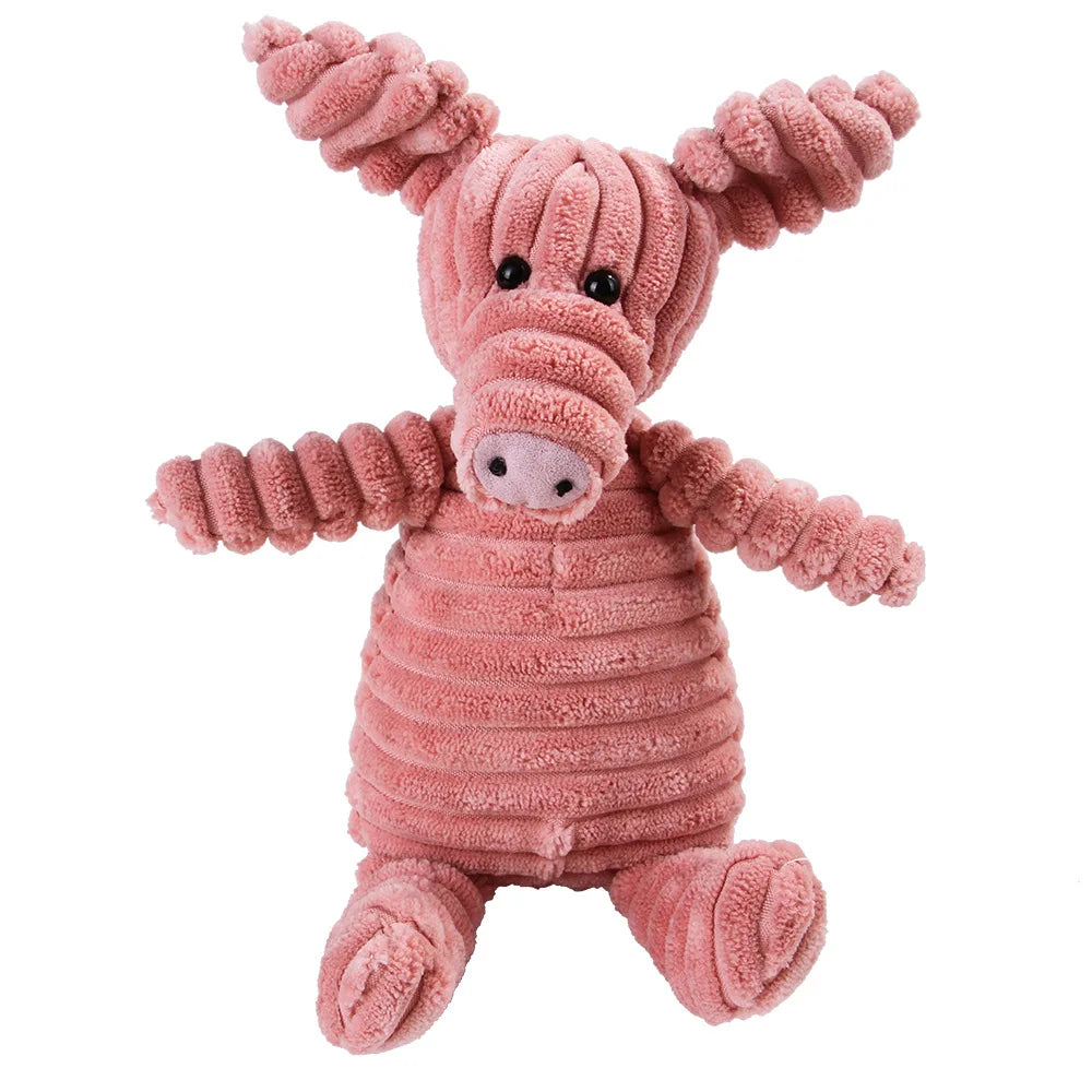 Jouet en peluche rose texturé en forme de porc pour le nettoyage dentaire.