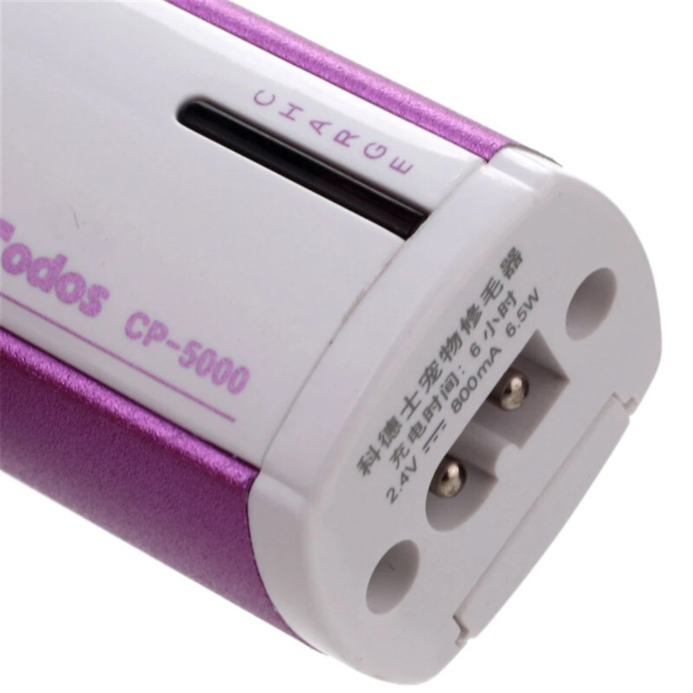 A close-up view of a white and purple electric pet grooming clipper with a charge indicator and power input port.