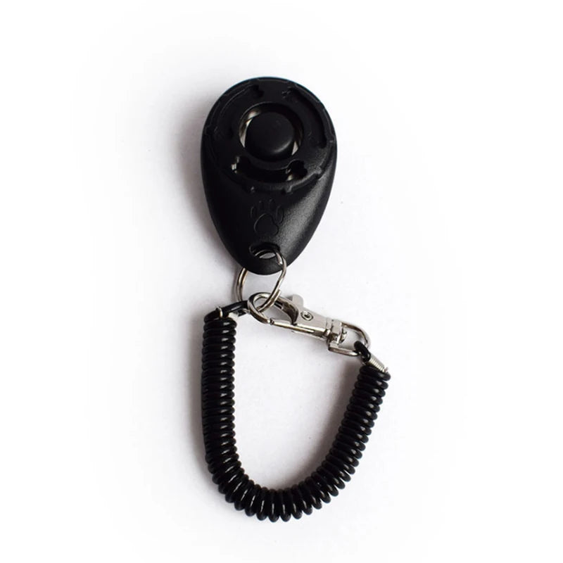 Black pet training clicker with a metal wrist strap attached.