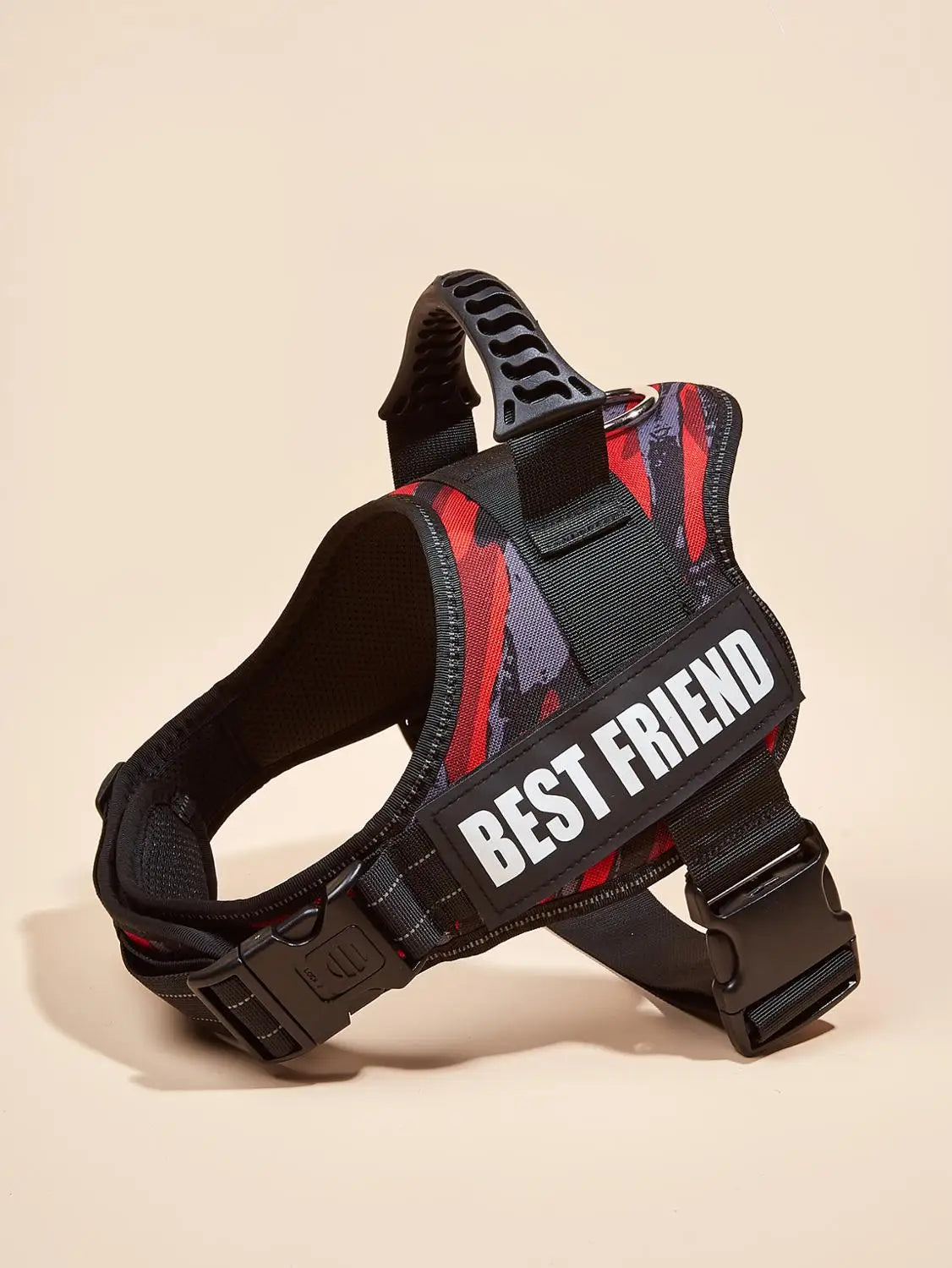 A black dog harness vest with red and black patterned fabric and a white Best Friend ID tag.