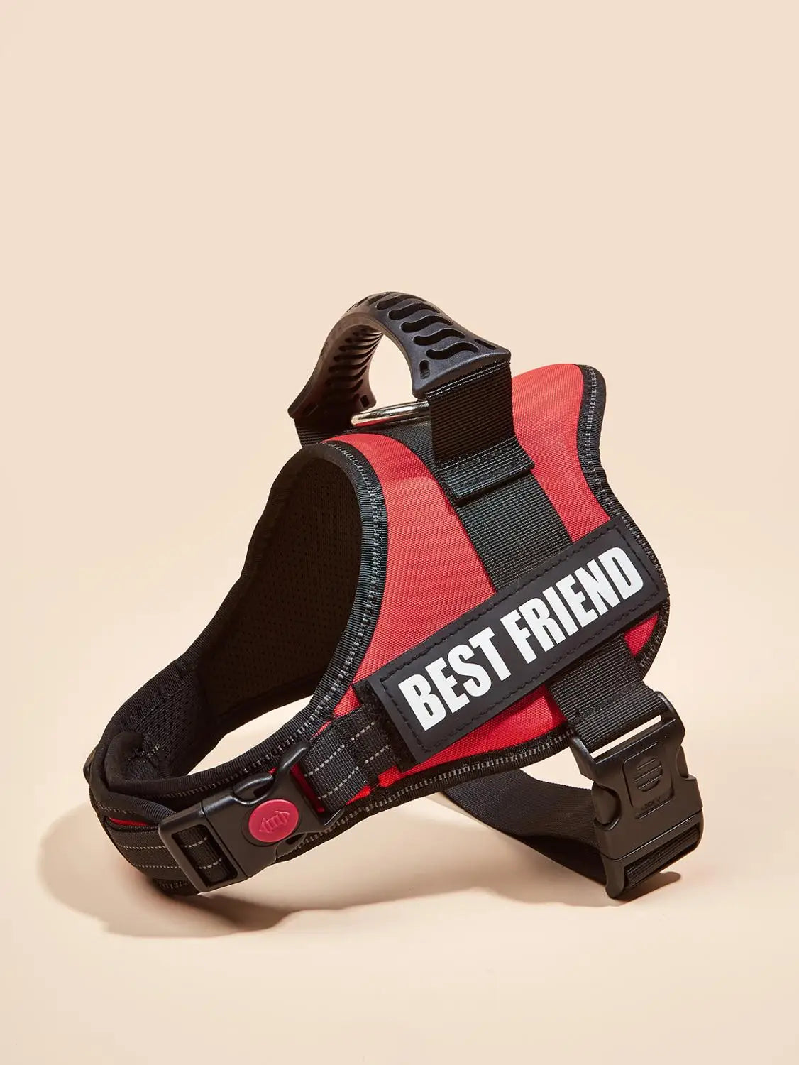 A red and black dog harness vest with reflective stripes and a black strap is shown against a light background.