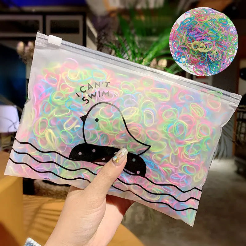 Klare Plastiktüte gefüllt mit bunten Gummibändchen in Form eines Enten und Schwimmlinien.