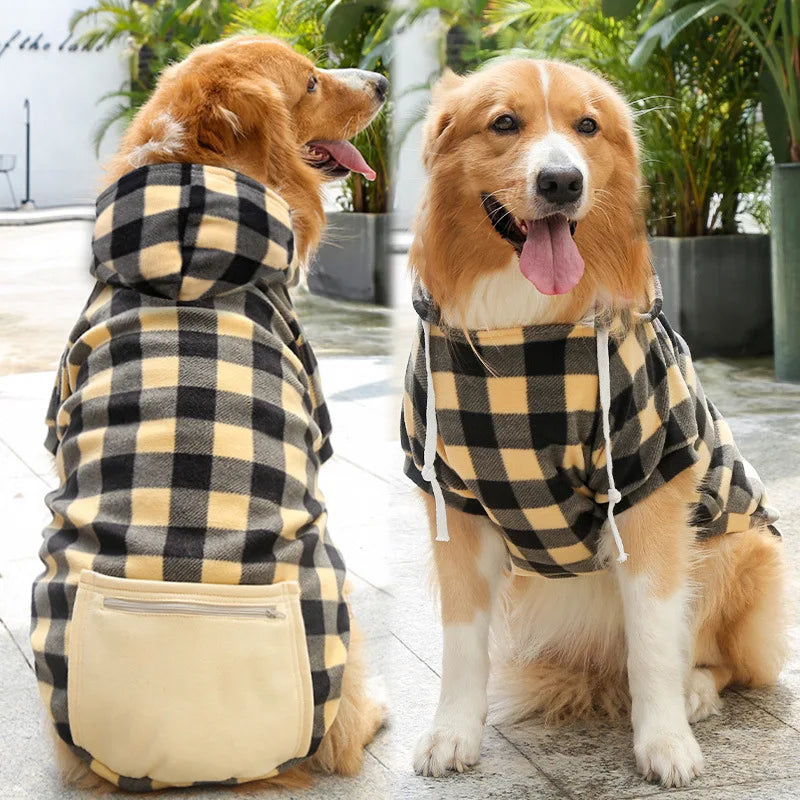 A dog wearing a reversible plaid jacket with a cozy fleece lining, shown in a yellow and black pattern.