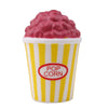 A cup of pink popcorn in a yellow striped paper cup.