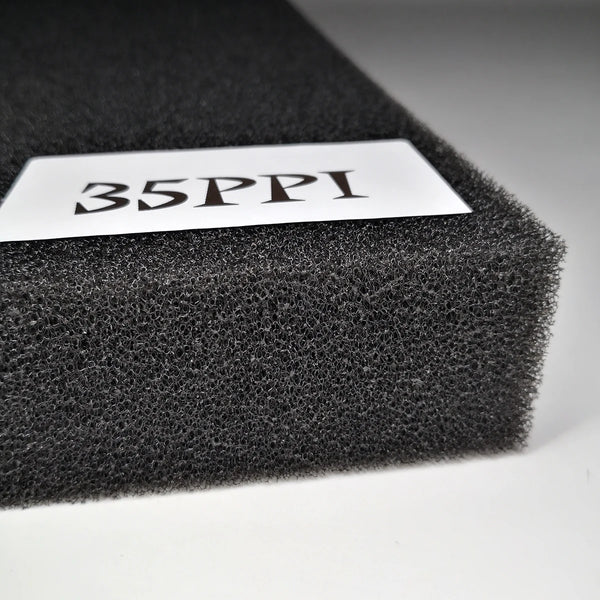 A white label with the text 35PPI is placed on a black aquarium biochemical filter sponge.