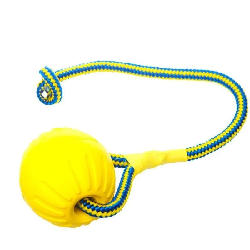 Yellow rubber dog chew ball with a braided rope for fetch and training