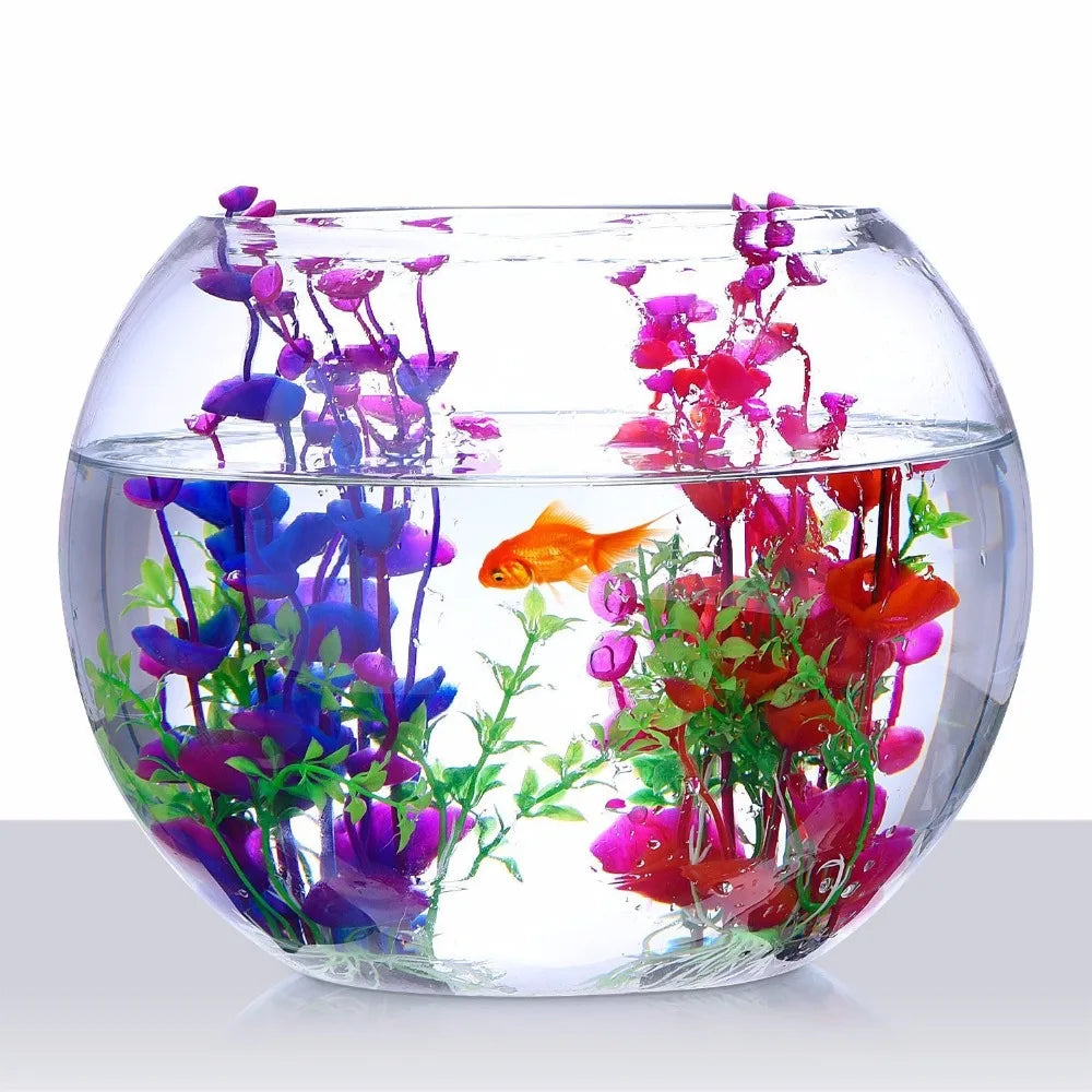 A clear glass bowl filled with artificial purple, pink, and red flowers resembling an aquarium plant.