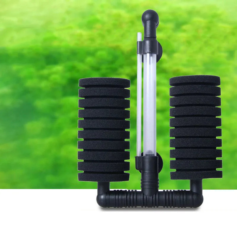 A black aquarium biochemical sponge filter with a clear tube and black foam pads is shown against a green background.