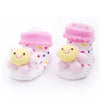 Pair of pink fuzzy animal cartoon baby socks with yellow embroidered faces