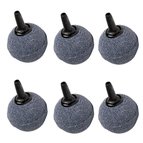 A set of five dark gray, round aquarium air stones with black nozzles.