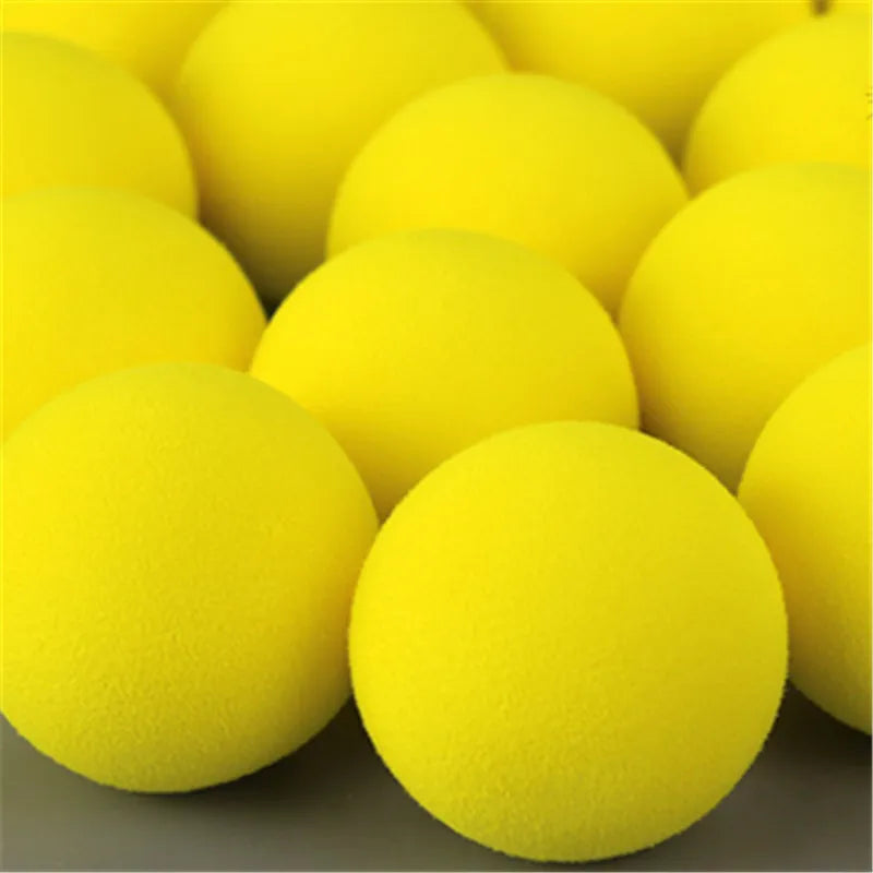 A close-up view of a pack of bright yellow EVA foam practice golf balls.