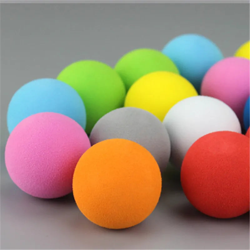 A collection of colorful EVA foam practice golf balls in various shades including blue, green, yellow, pink, and orange.