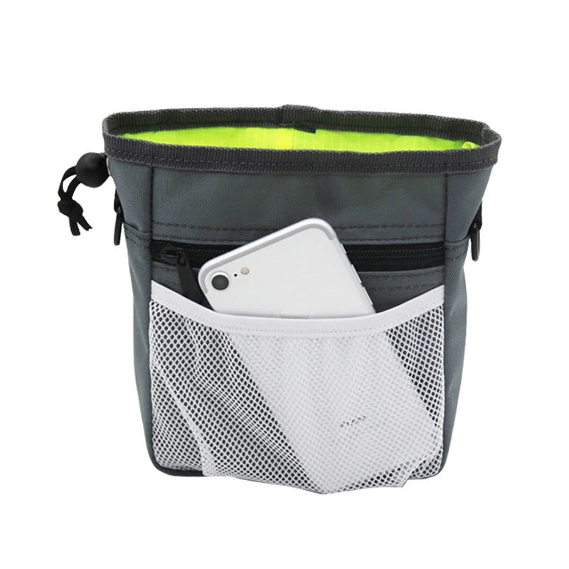 A gray pouch for dog training treats with a lime green lining and a white mesh pocket for holding a smartphone.
