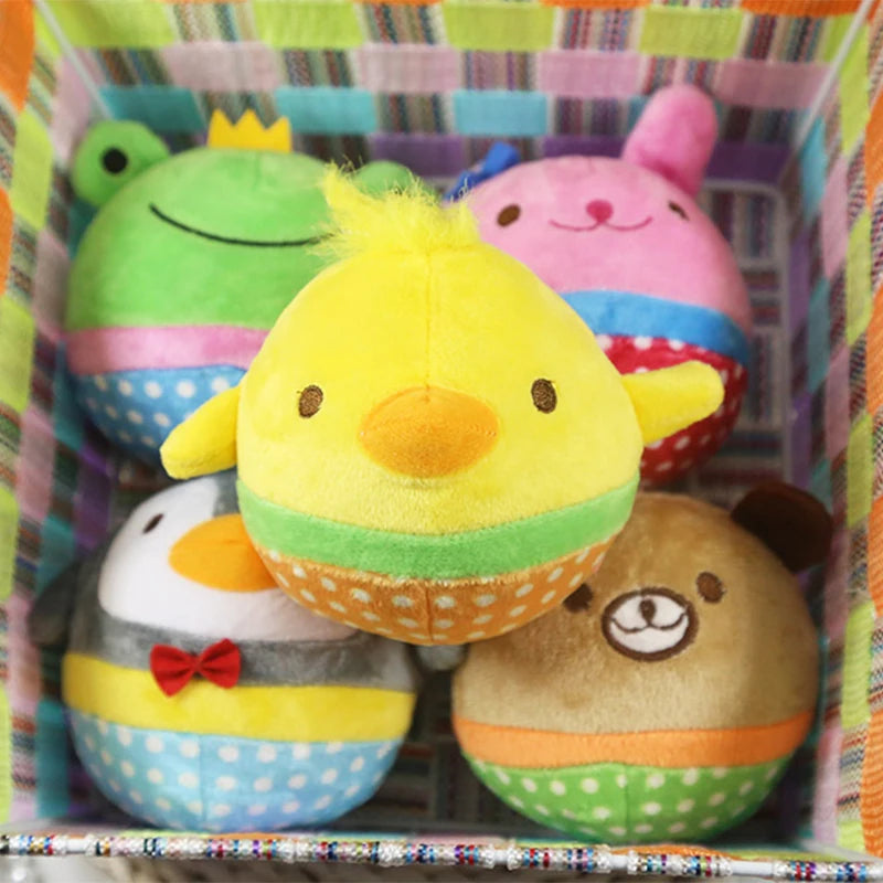 A colorful assortment of cute plush squeaker dog toys including a green frog, pink bear, yellow chick, and brown bear.