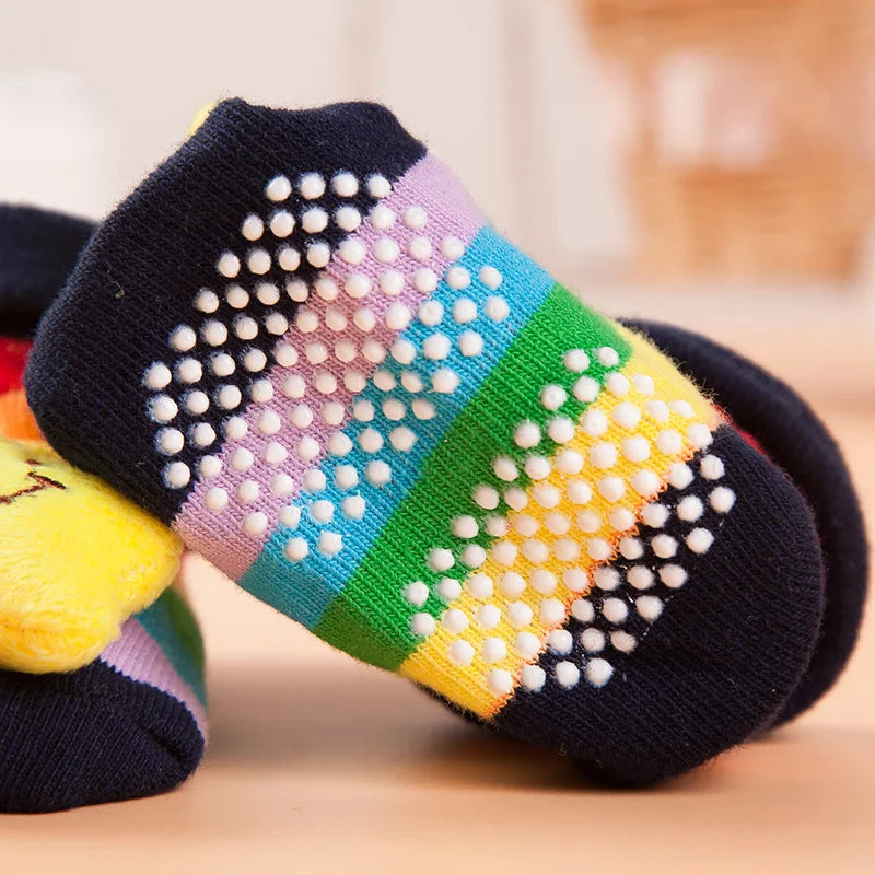 Colorful striped baby socks with a pattern of white dots and yellow accents