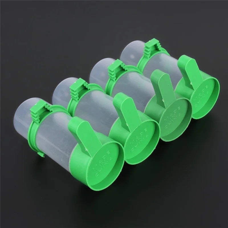 A set of green clip-on bird feeder and waterer components for small parrots and budgies.