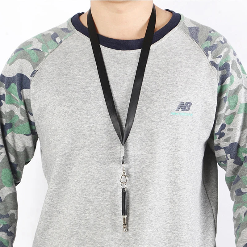 Gray long-sleeve shirt featuring an Under Armour logo and a black lanyard with a silver charm.