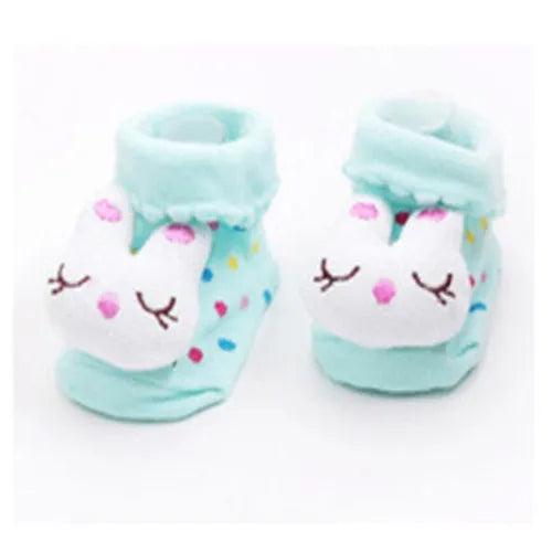 Pair of light blue baby socks with cute white animal cartoon faces