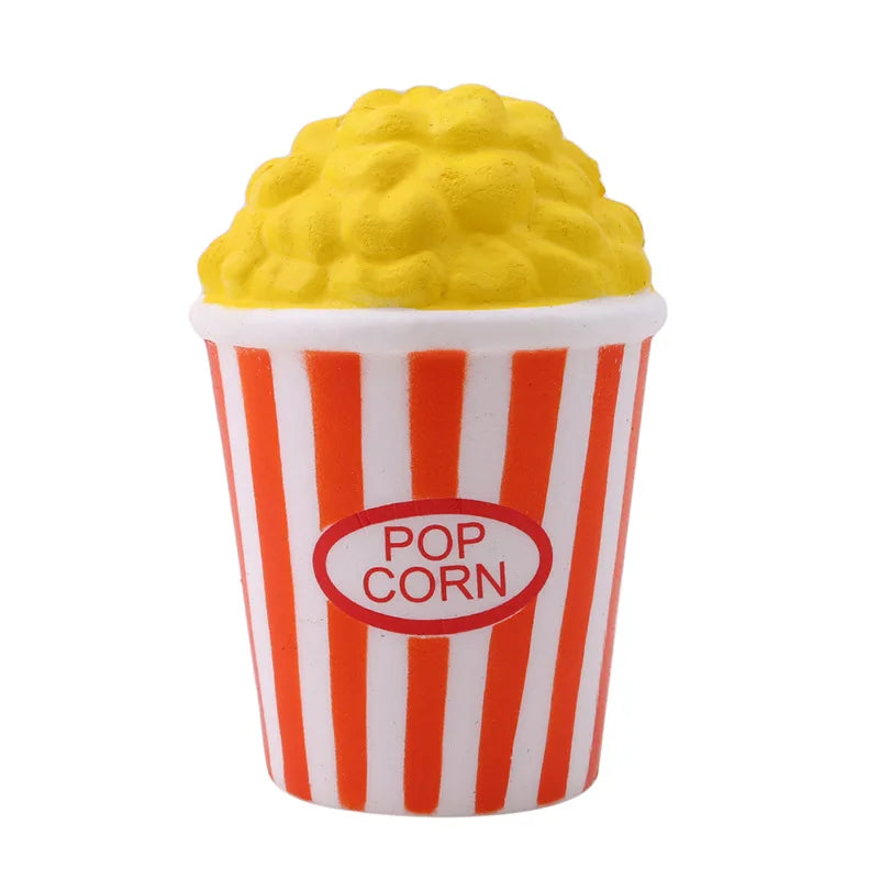 A yellow corn-shaped squishy toy is visible inside a striped paper cup labeled POP CORN.