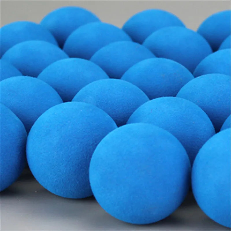 A pile of bright blue EVA foam practice golf balls used for indoor and outdoor training.